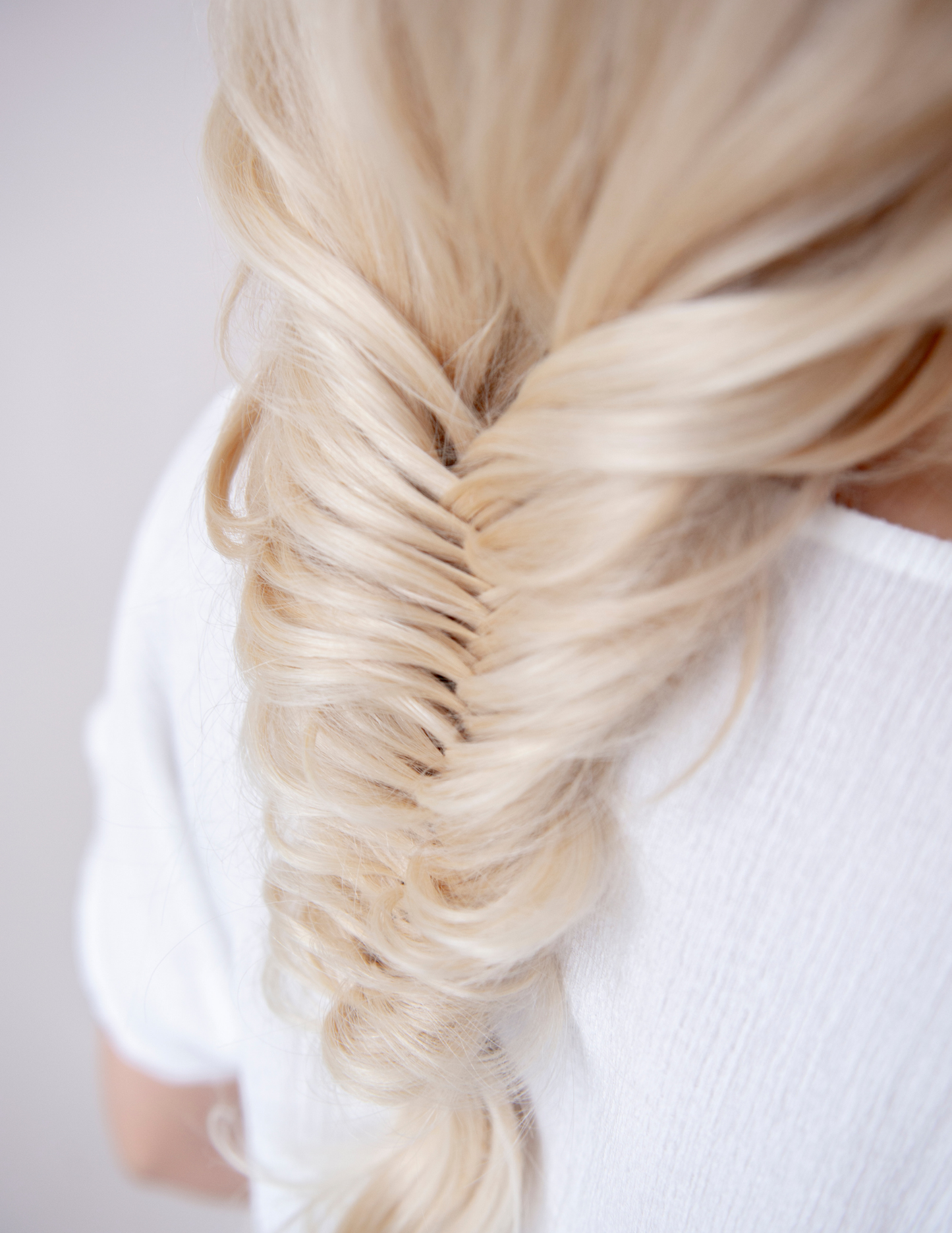 Blond wavy hair extension showcasing luxurious texture and natural movement.