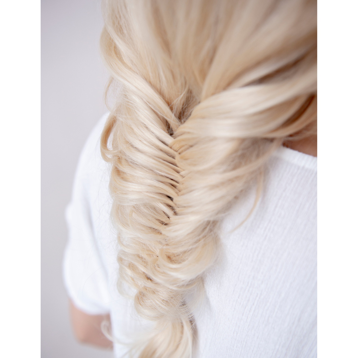 Blond wavy hair extension showcasing luxurious texture and natural movement.