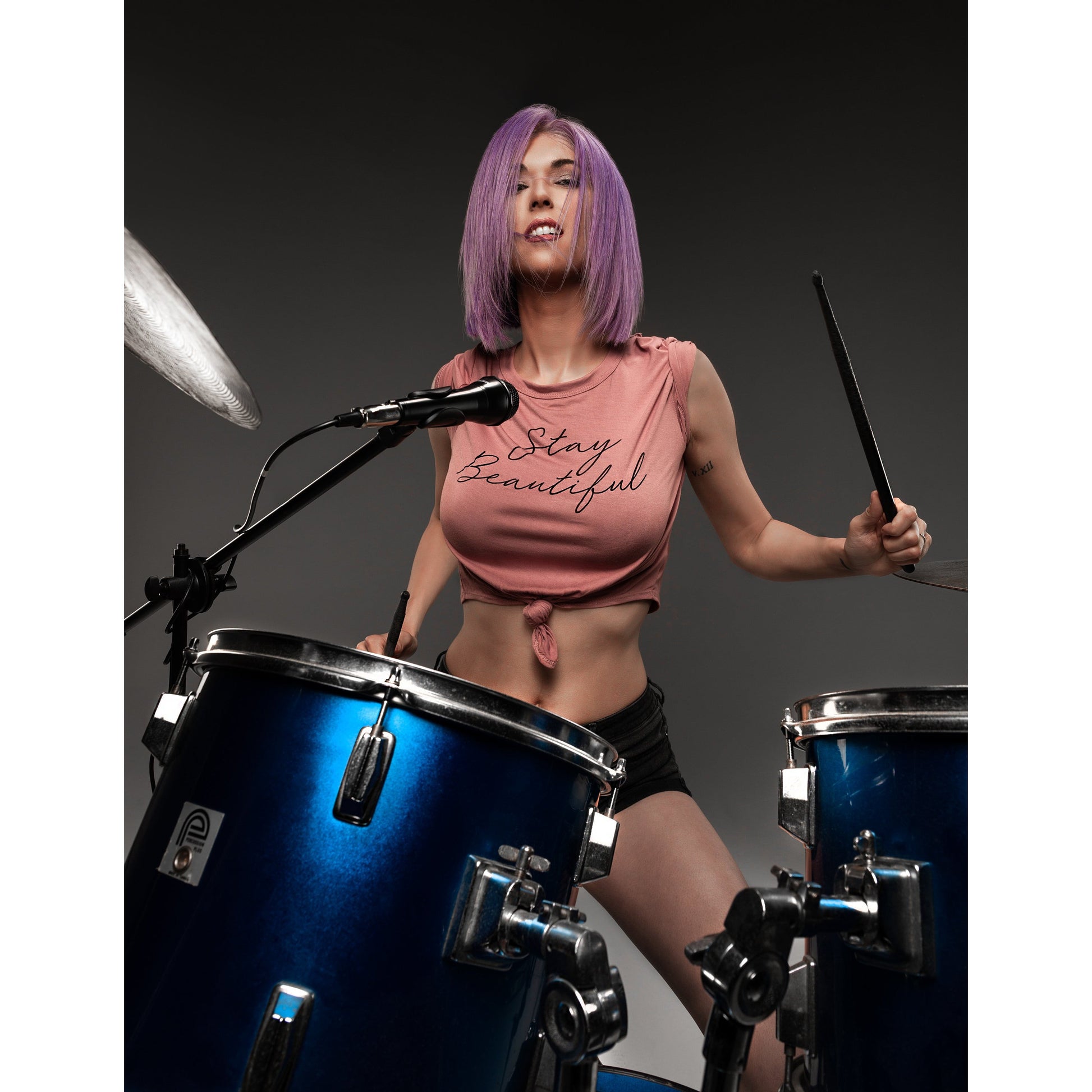 Woman drumming wearing Bombshell Bob Wig with angled precision cut.